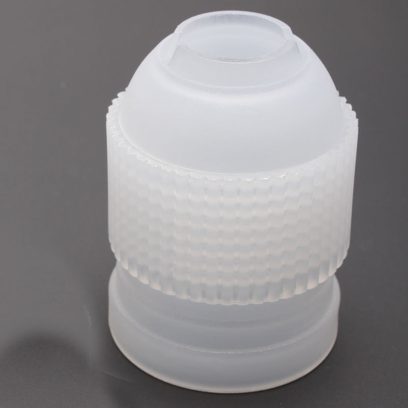 Plastic piping coupler on a dark grey background